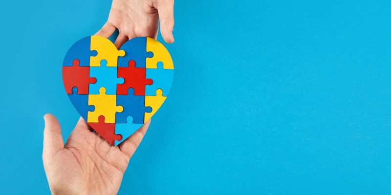 father-autistic-son-hands-holding-jigsaw-puzzle-heart-shape-world-autism-awareness-day (2)-min